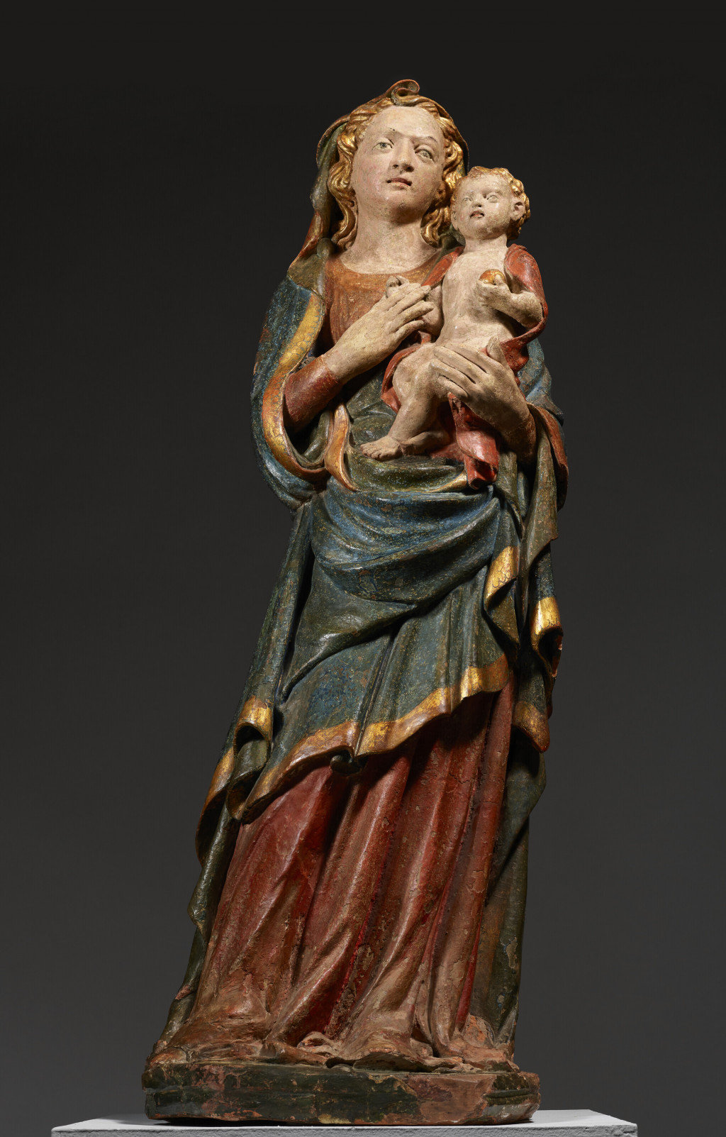 A GILT AND POLYCHROMED TERRACOTTA FIGURE OF THE VIRGIN AND CHILD.jpg